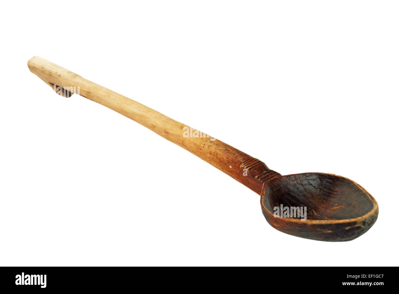old used wooden spoon isolated over white background, household traditional object Stock Photo