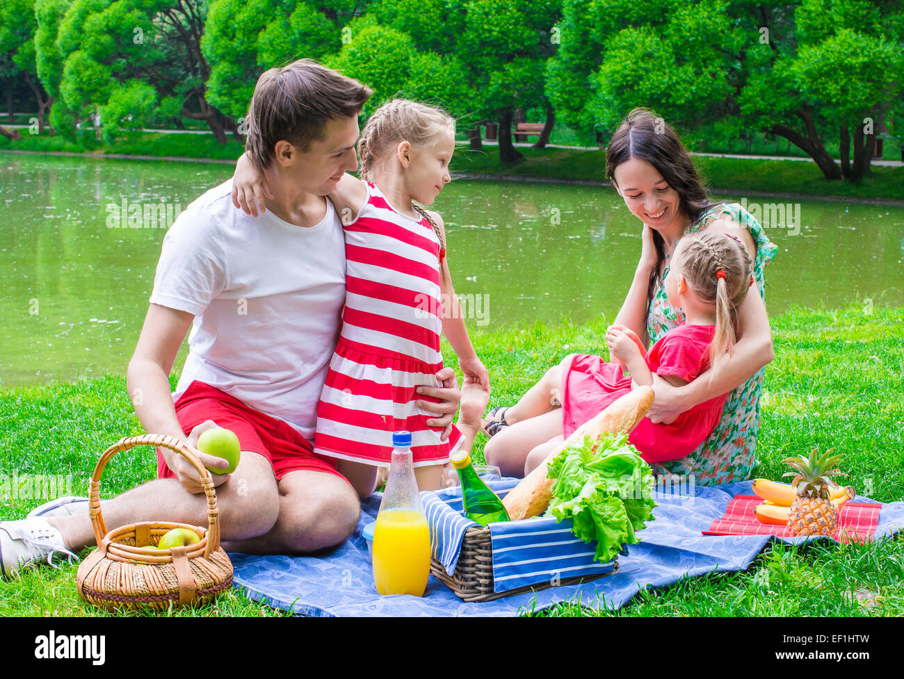 Happy family picnicking in the park Stock Photo - Alamy