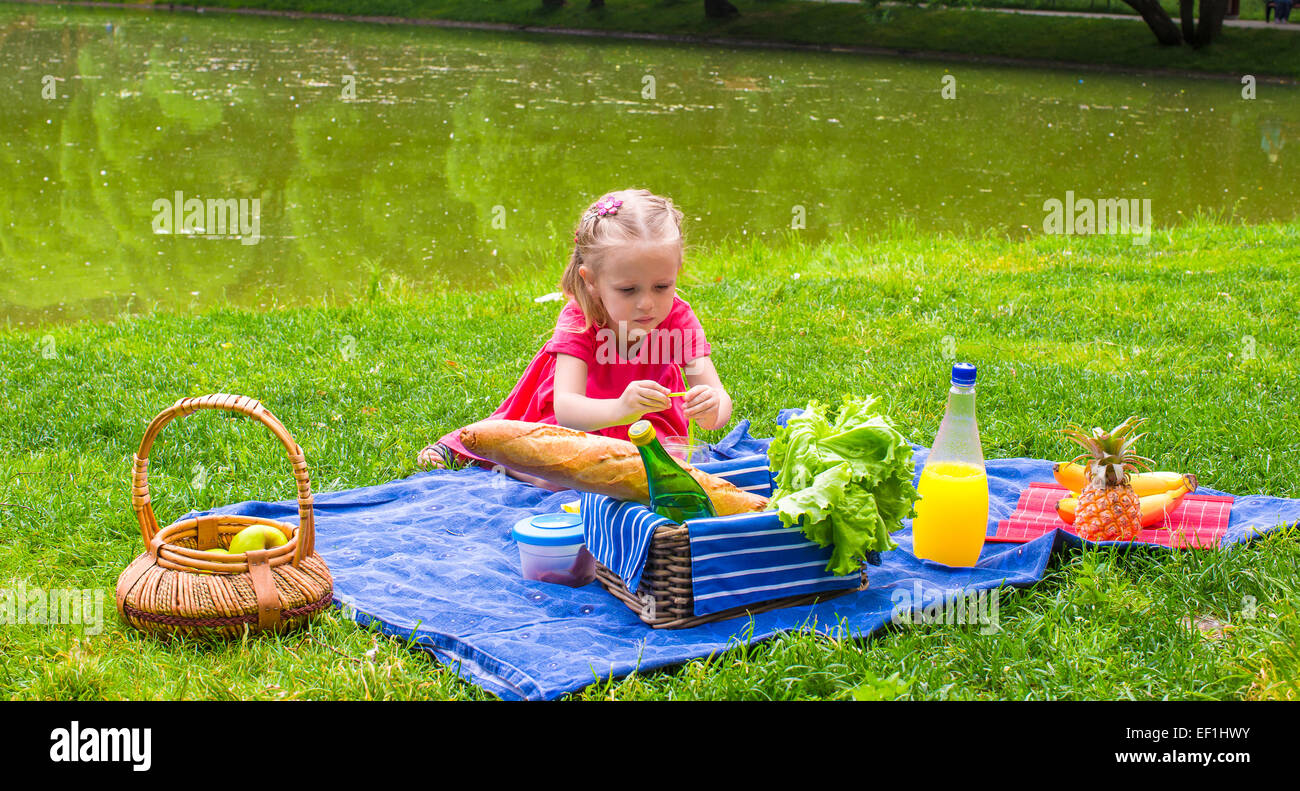 Adorable little girl on picnic outdoor near the lake Stock Photo - Alamy