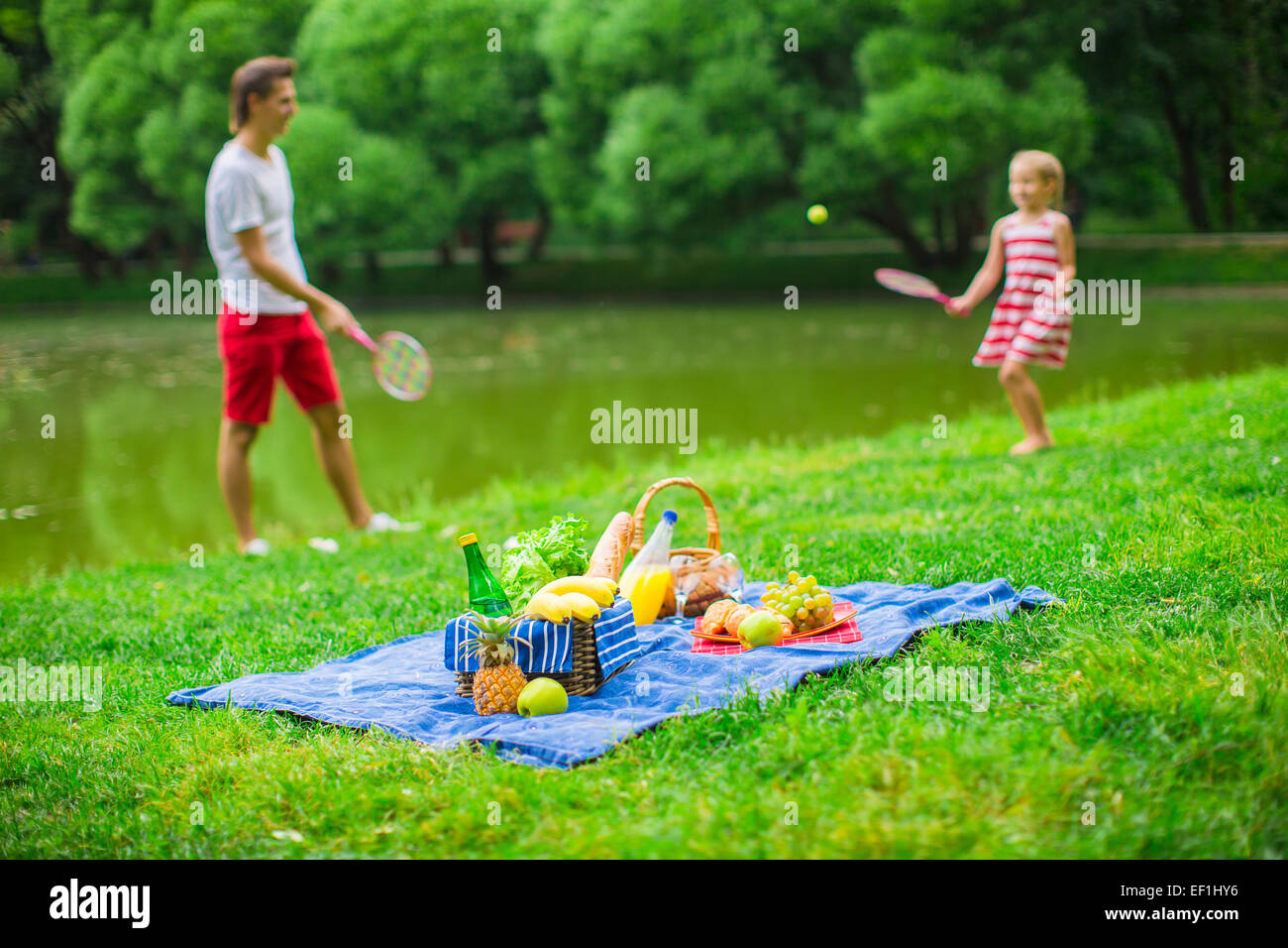 Happy family picnicking in the park Stock Photo - Alamy
