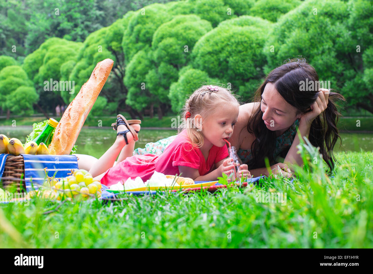 Happy family of two picnicking in the park outdoor Stock Photo - Alamy
