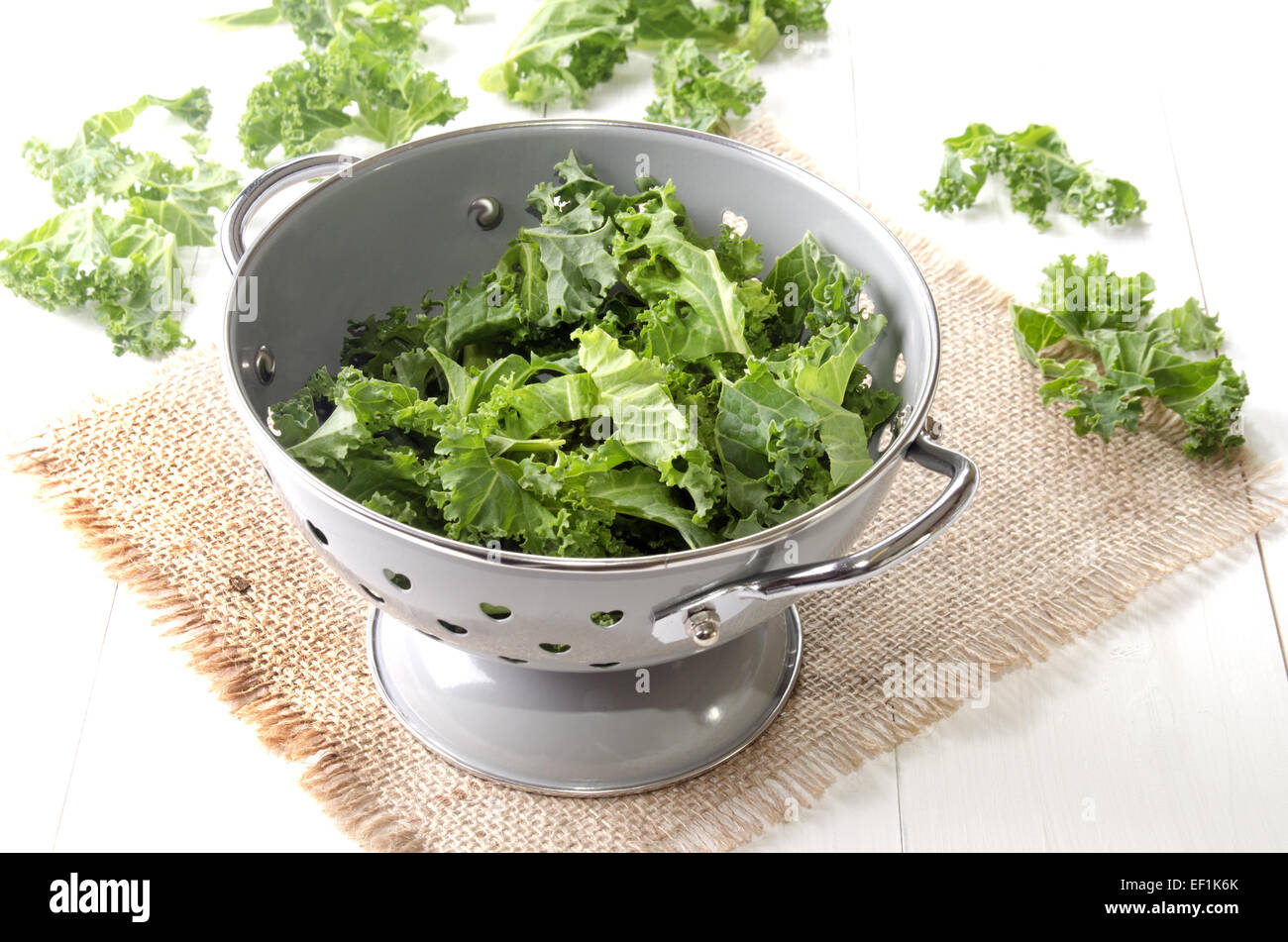 colander on jute with fresh curly kale Stock Photo