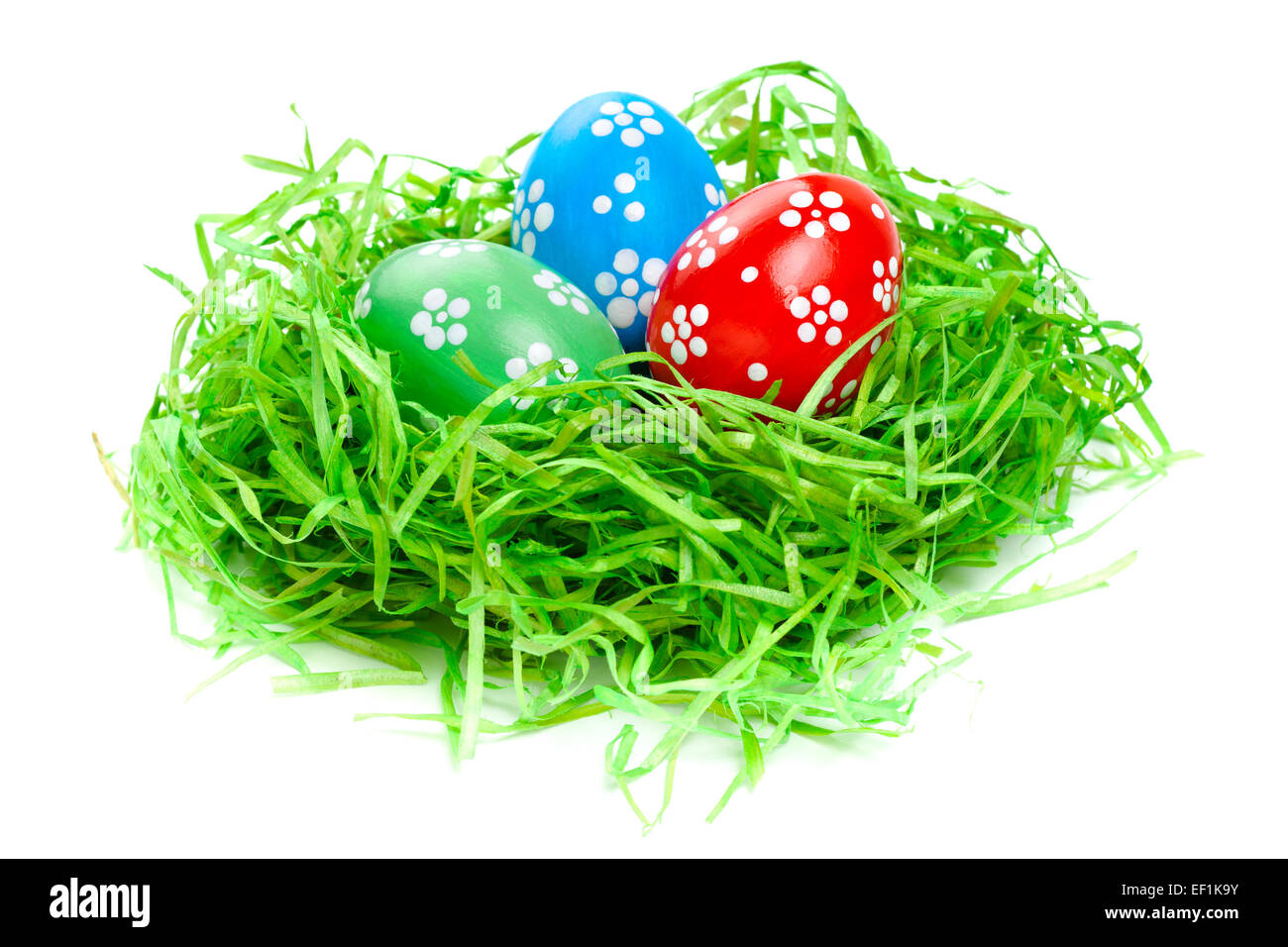 easter eggs in straw nest on white Stock Photo - Alamy
