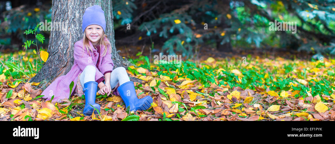 Little happy girl in autumn park on sunny fall day Stock Photo - Alamy