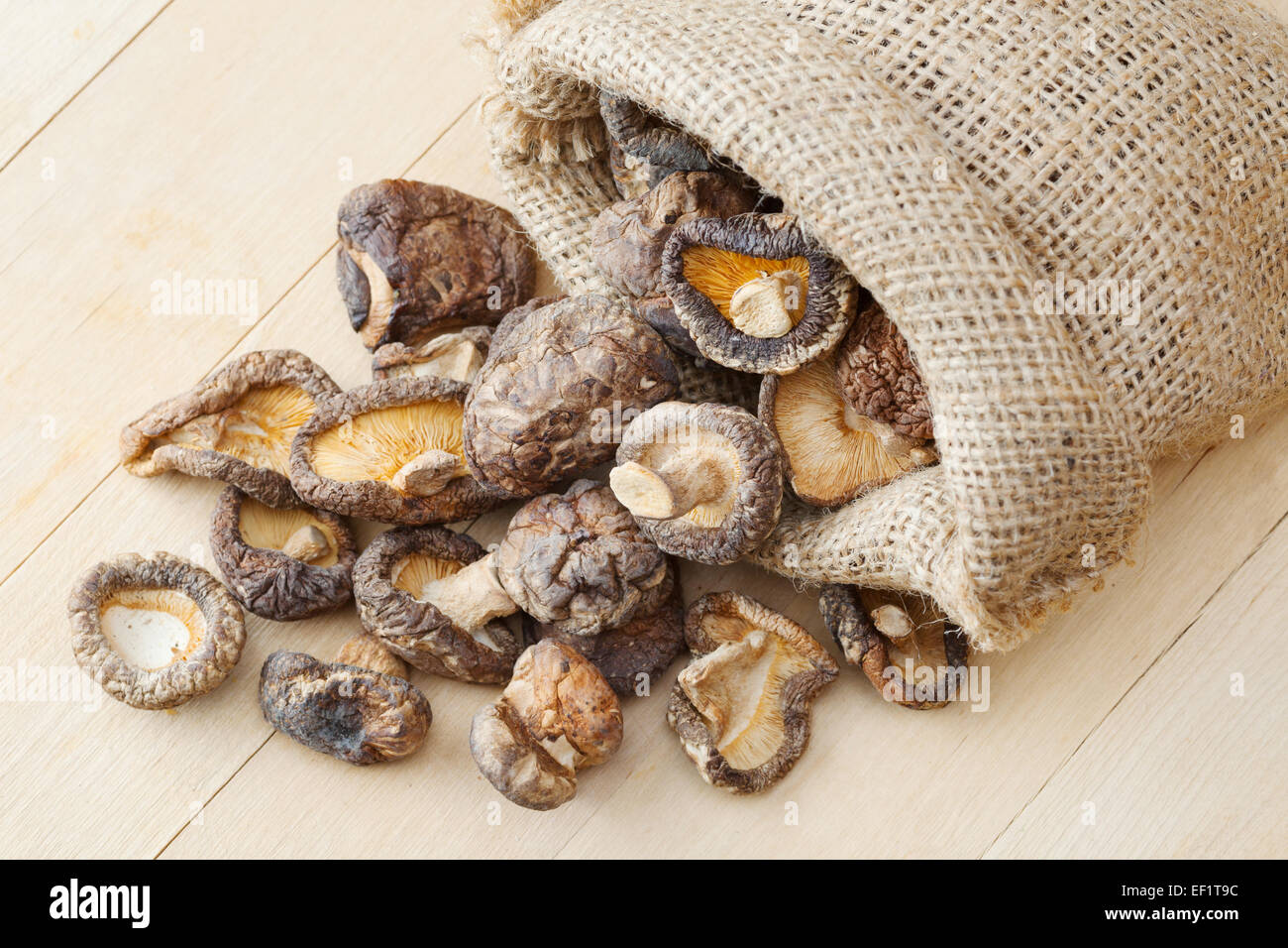dried shiitake mushroom in hessian bag on kitchen table Stock Photo
