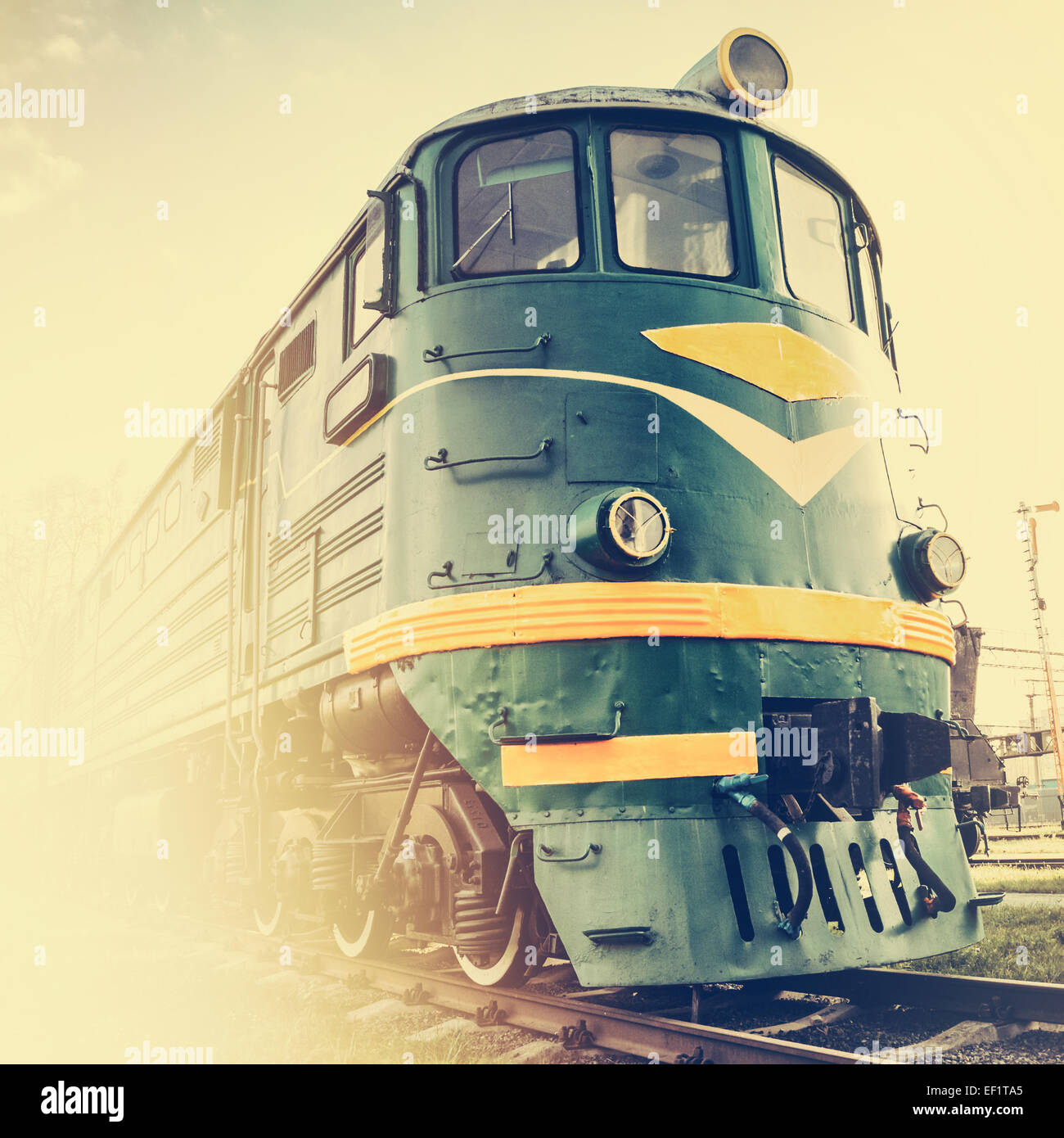 diesel locomotive on railway station, retro stylized Stock Photo