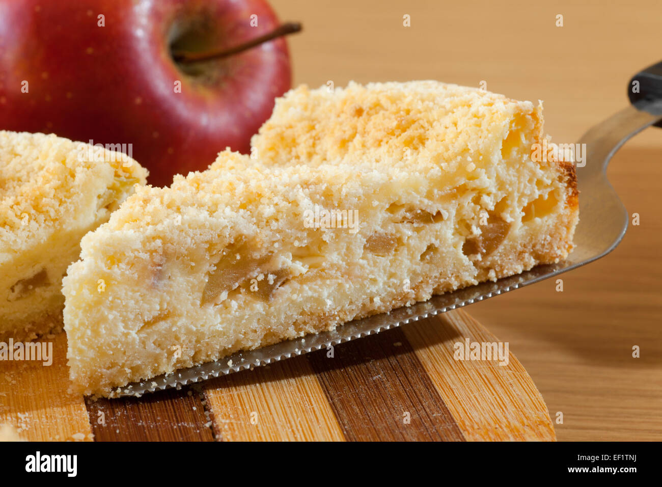 piece of cheesecake with apple on kitchen table Stock Photo
