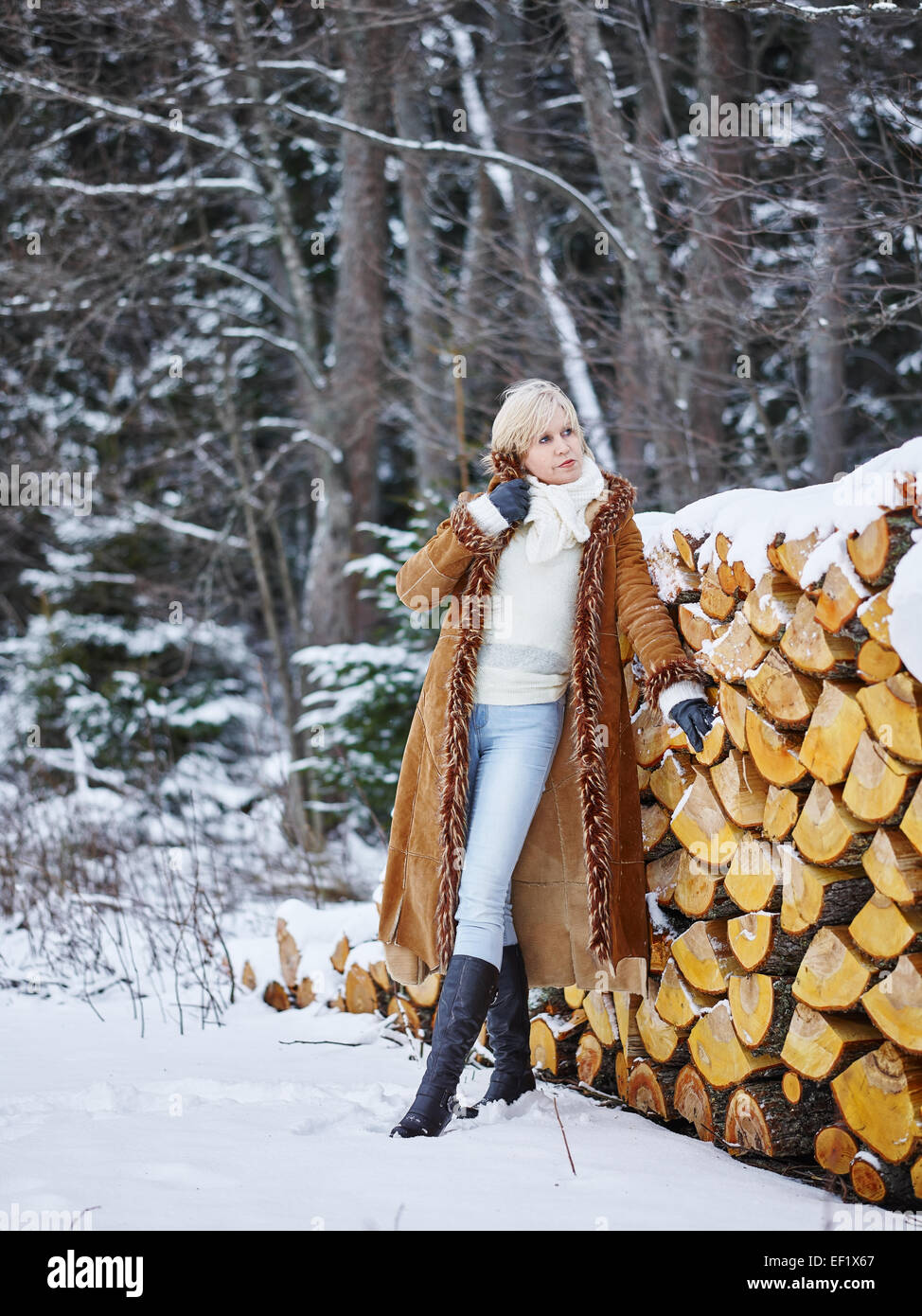 Fashionable mature adult woman wearing winter clothes, rural scene Stock Photo