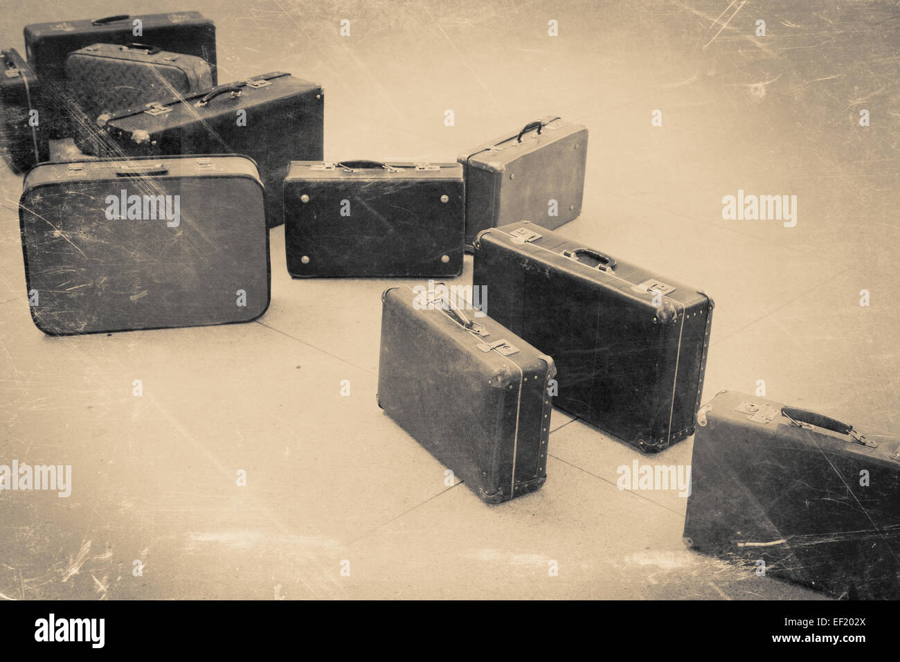 group of vintage suitcase on tiled floor, retro stylized in black and white color photo Stock Photo