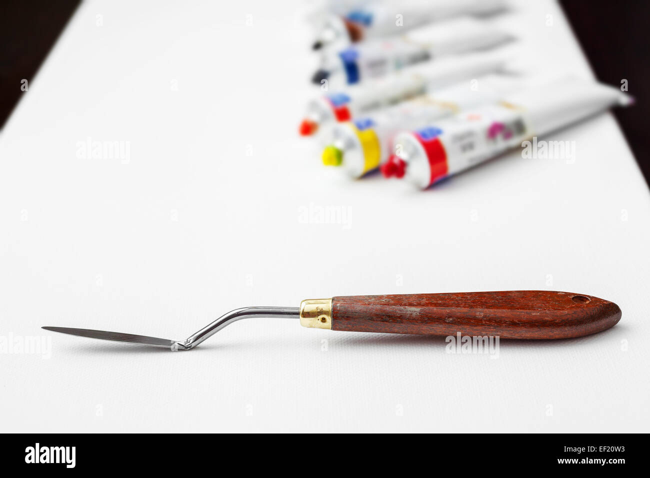 Set of artist accessories collection. Canvas, tube of oil paint, art brushes,  palette knife lying on the wood table. Artist workshop background Stock  Photo - Alamy