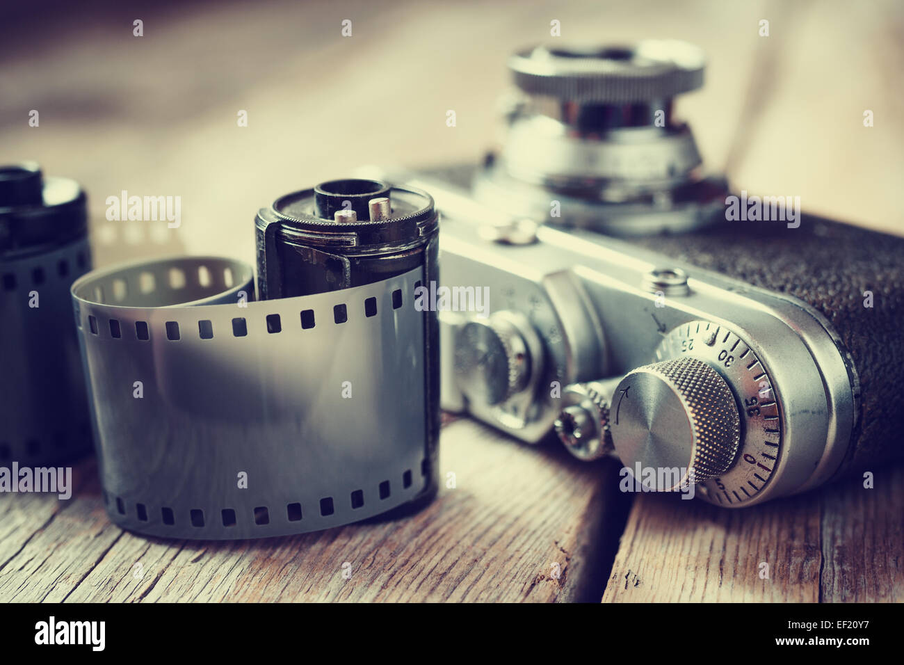 Old photo film rolls, cassette and retro camera, selective focus. Vintage stylized. Stock Photo