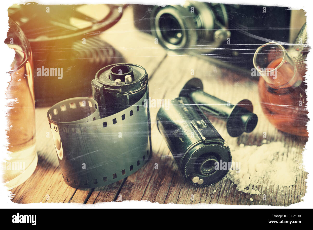 Old photo film rolls, cassette, retro camera and chemical reagents for photographic film. Vintage stylized. Stock Photo