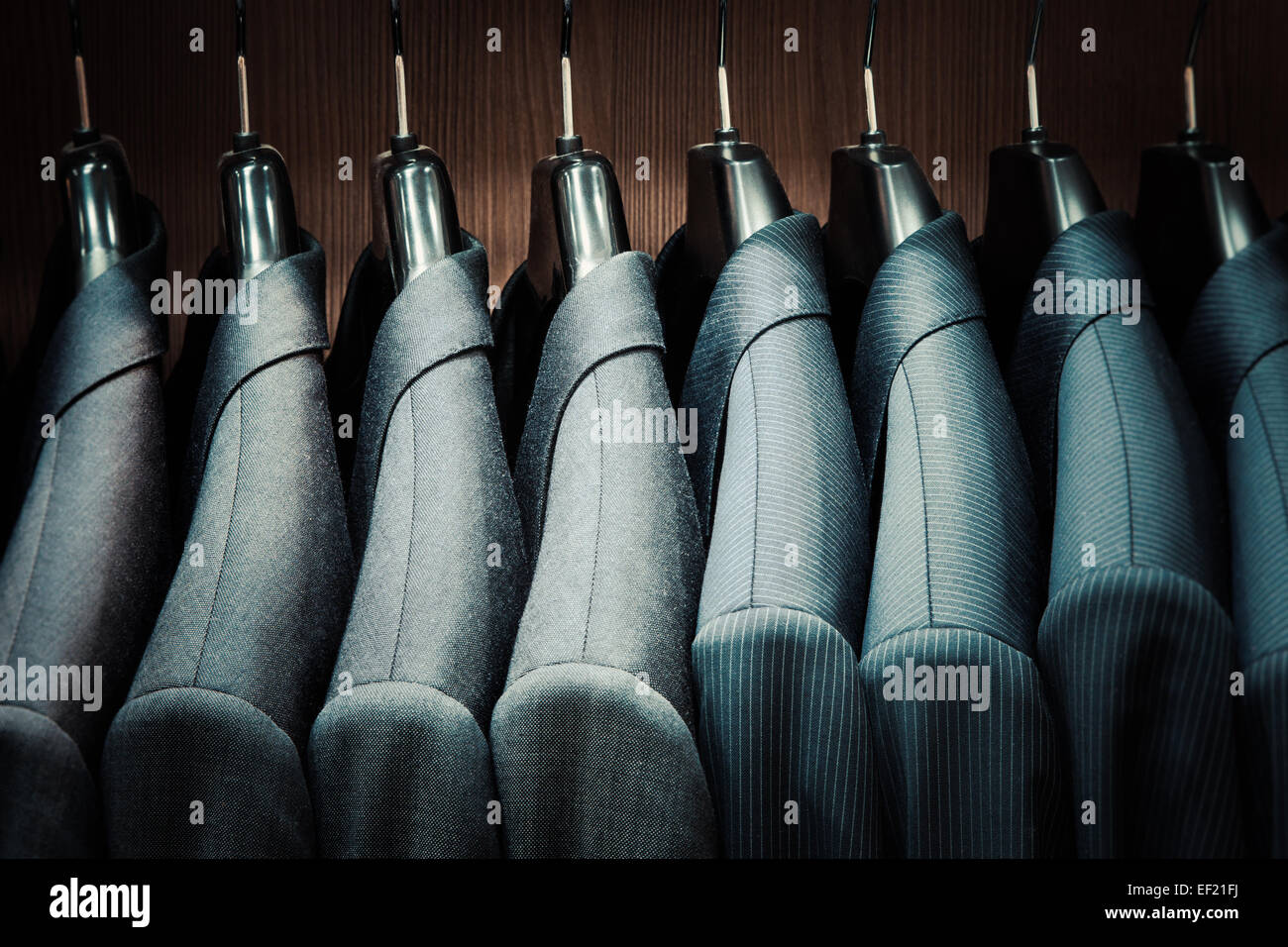 Row of men suit jackets on hangers Stock Photo