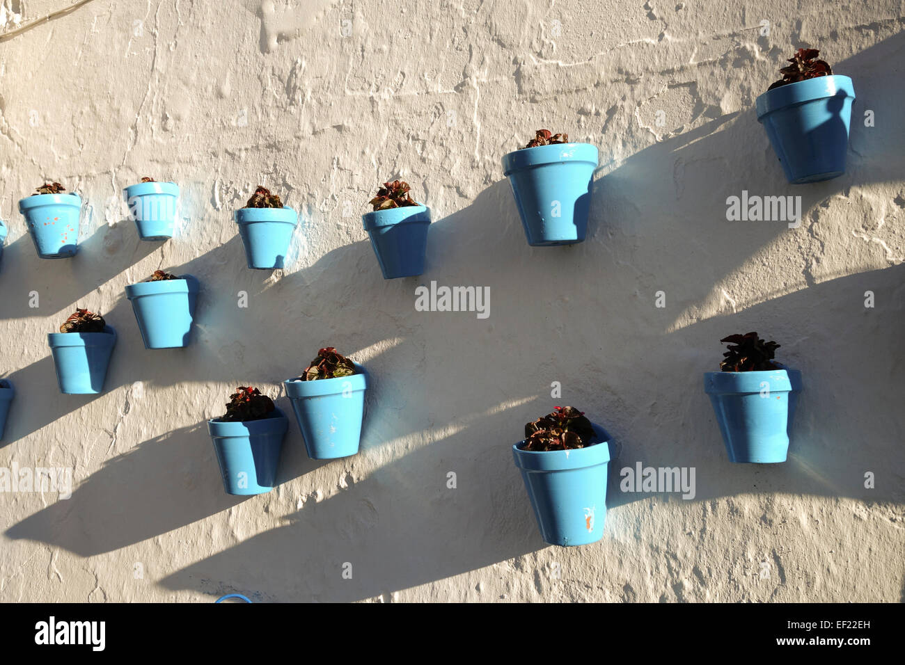 Blue flower pots in white washed village of Mijas, Andalusia, Southern Spain. Stock Photo