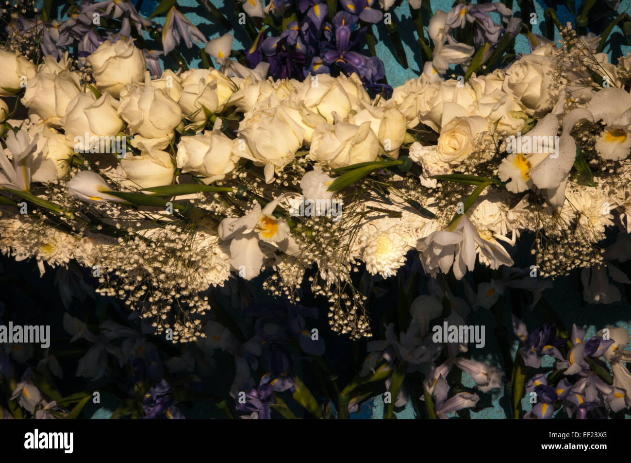 flower swag hanging, made of roses, daffodils, baby breath, carnations. White & purple. Stock Photo