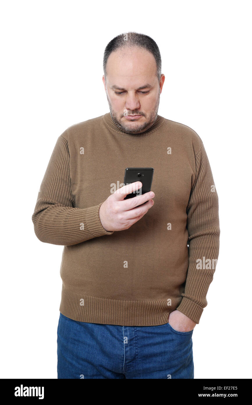 middle aged man looking down at his mobile smart phone Stock Photo