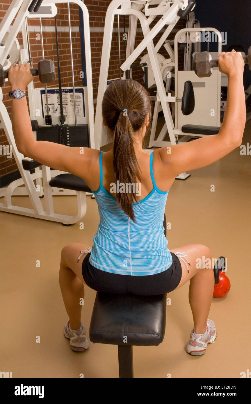 Woman lifting free weights Stock Photo