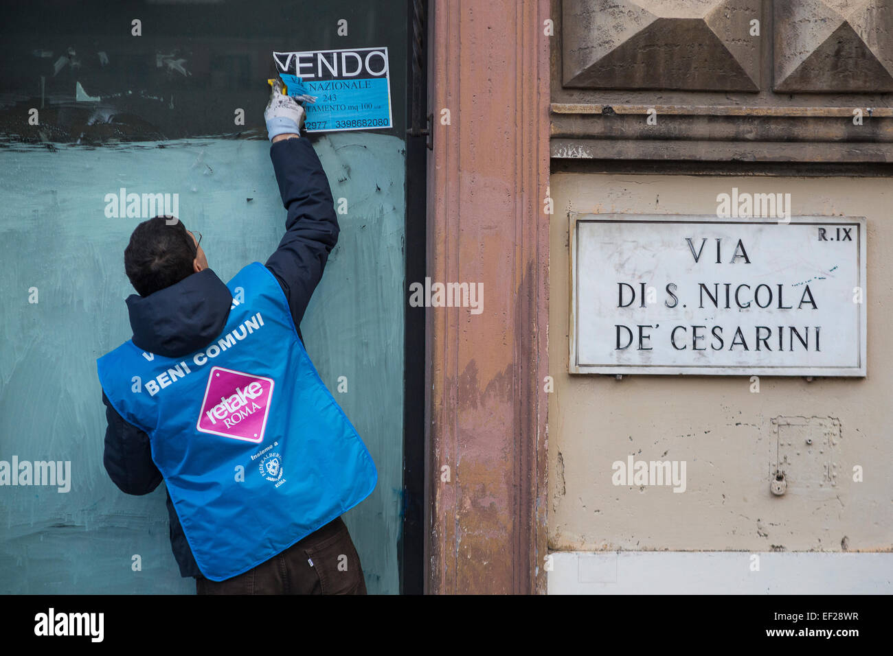 Rome, Italy. 25th January, 2015. Volunteers association RETAKE and national Hotel association Federalberghi, together to clean from stickers, illegal bill posts and graffiti in Largo Argentina, downtown Rome, helping sanitation municipal company AMA. Credit:  Francesco Gustincich/Alamy Live News Stock Photo