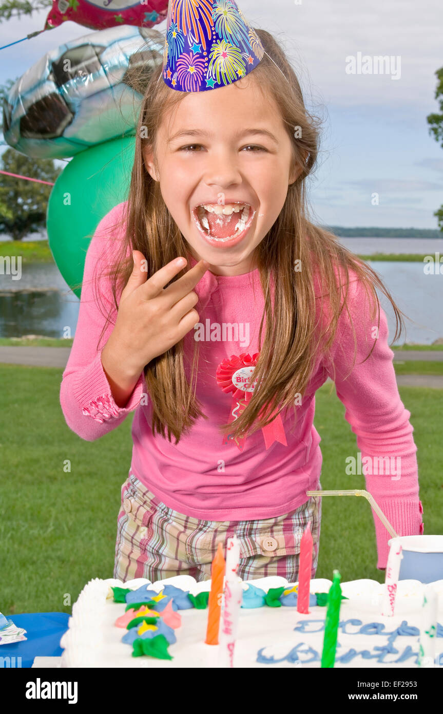 Girl eating birthday cake Stock Photo Alamy
