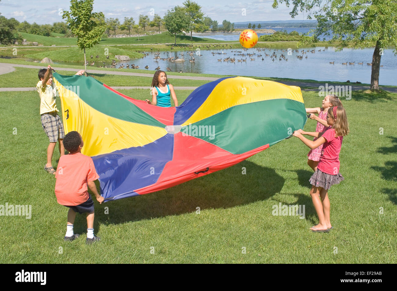 Children playing with a parachute Stock Photo Alamy