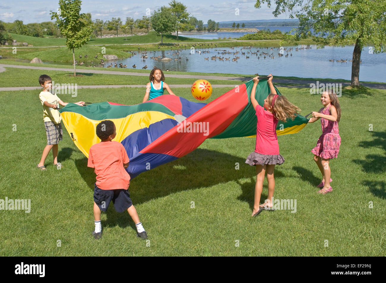 Children playing with a parachute Stock Photo Alamy