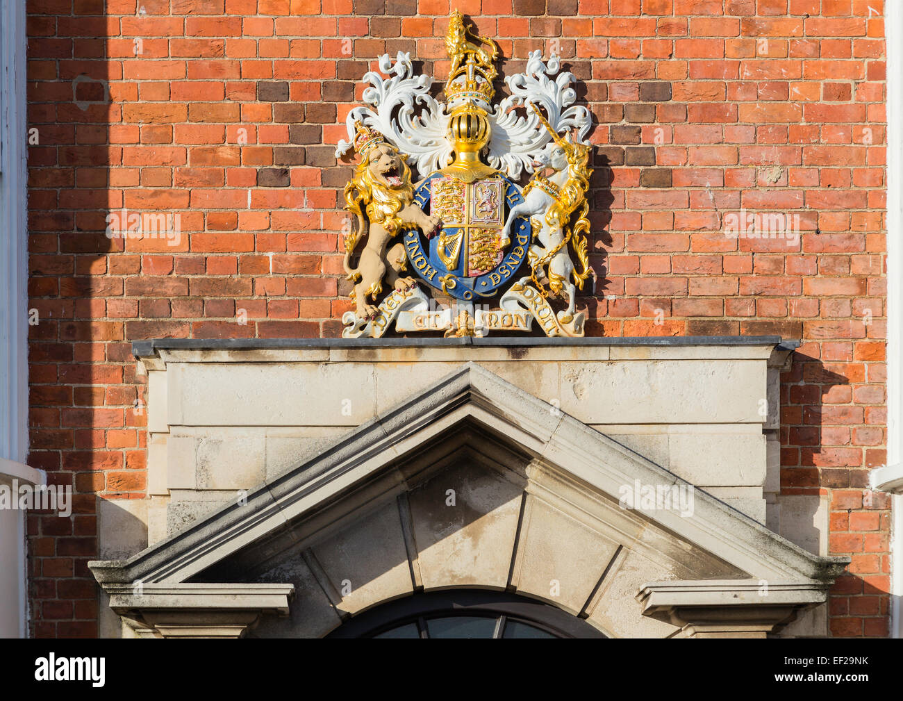 A Coat of Arms above a grand door with a pediment made of stone in Weymouth, Dorset, UK. Stock Photo