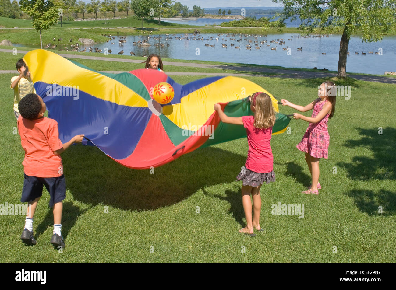 Children playing with a parachute Stock Photo