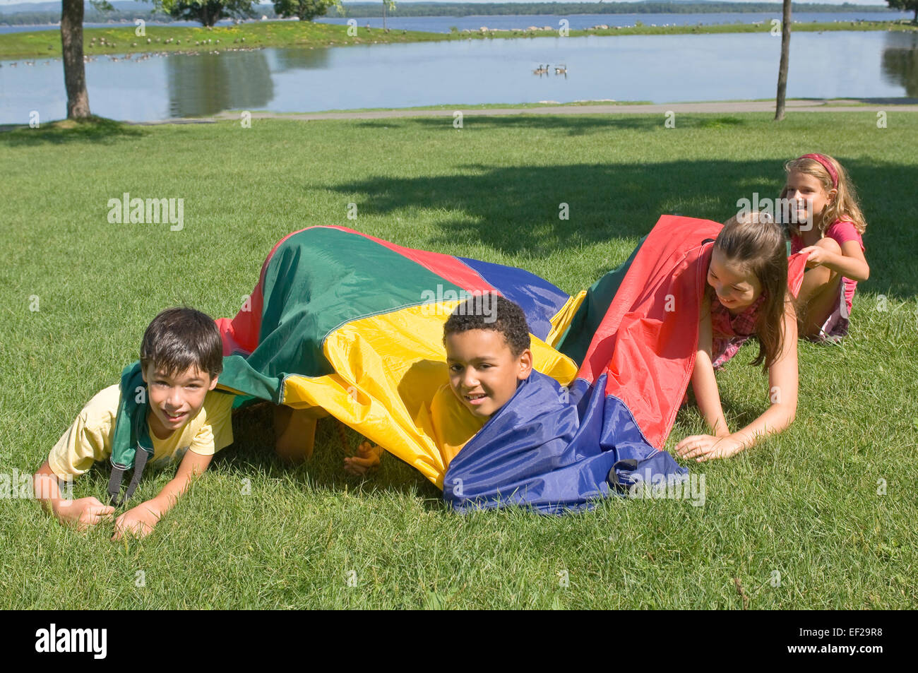 Group children play parachute game hires stock photography and images