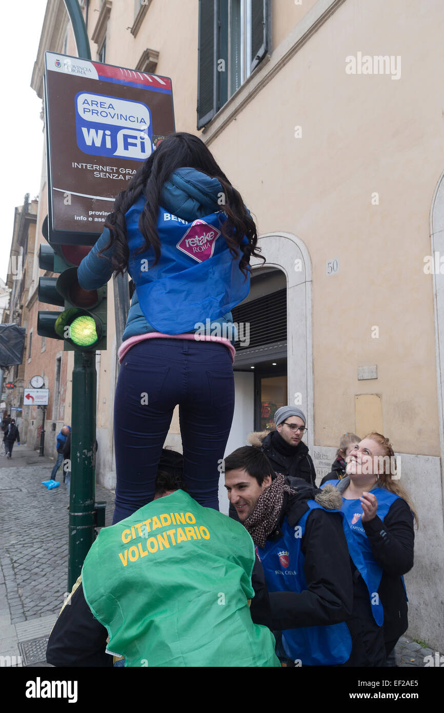 Rome, Italy. 25th January, 2015. Volunteers association RETAKE and national Hotel association Federalberghi, together to clean from stickers, illegal bill posts and graffiti in Largo Argentina, downtown Rome, helping sanitation municipal company AMA. Credit:  Francesco Gustincich/Alamy Live News Stock Photo