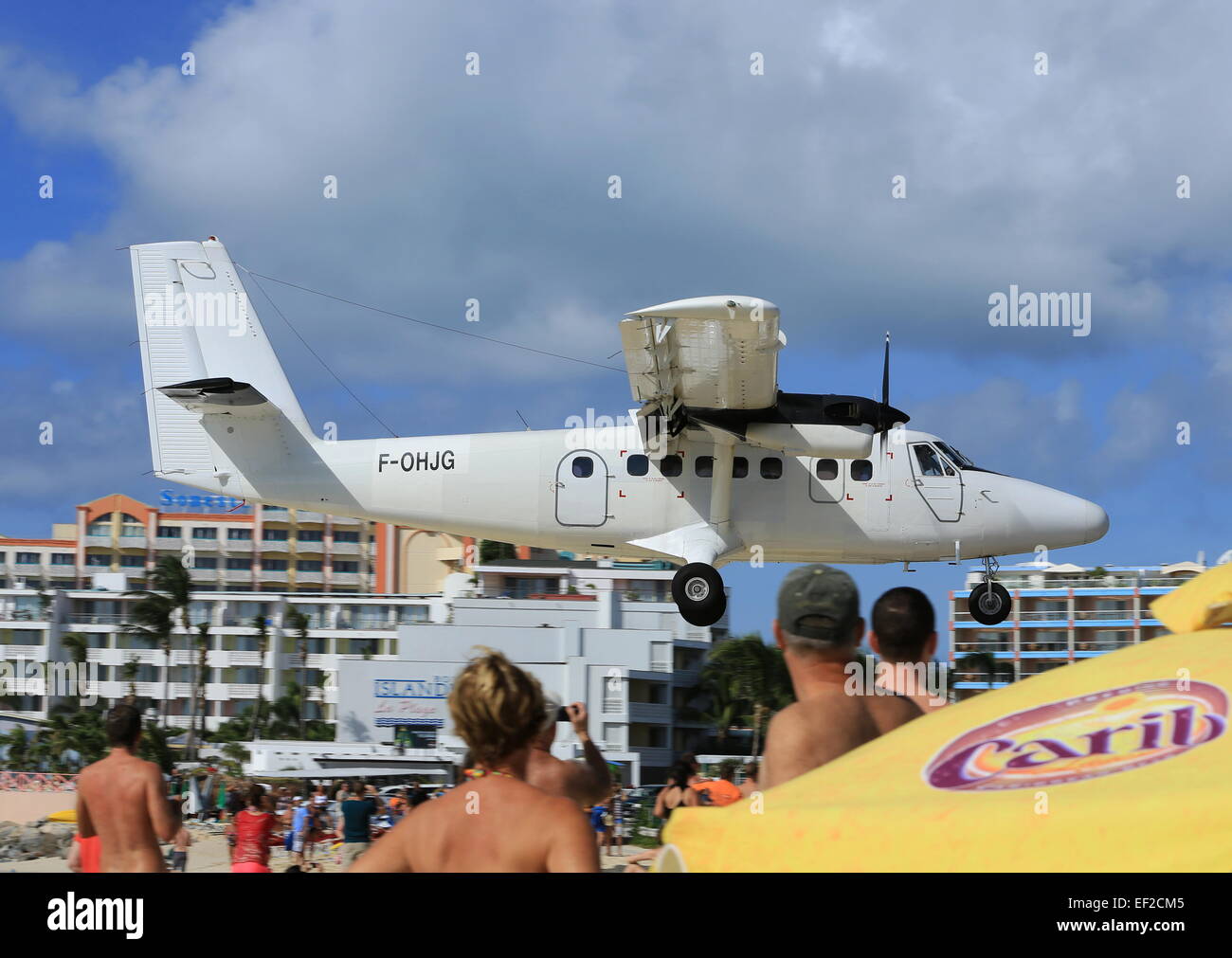 Air Caraibes operating on behalf of Winair making a low approach to land at Princess Juliana, Sint Maarten Stock Photo