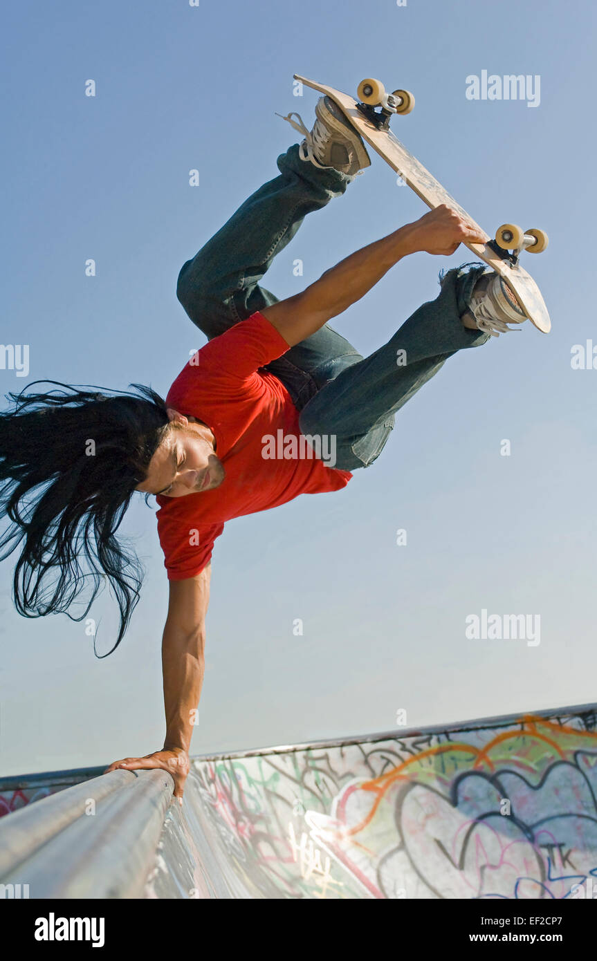 A young man skateboarding on a skateboard ramp Stock Photo