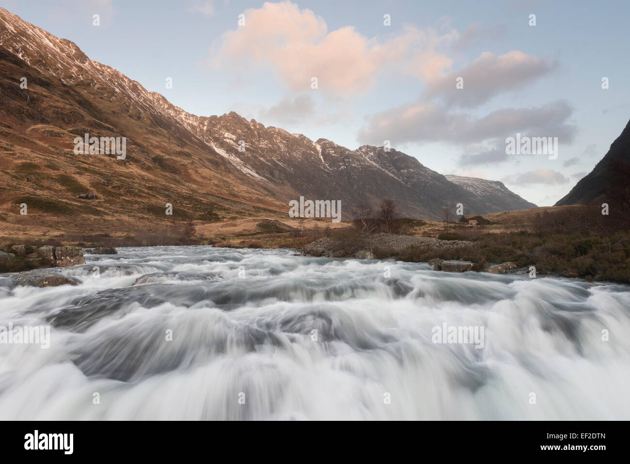 Surging rapids on the River Coe, with the Aonach Eagach ridge in the background, Glencoe, Scotland Stock Photo