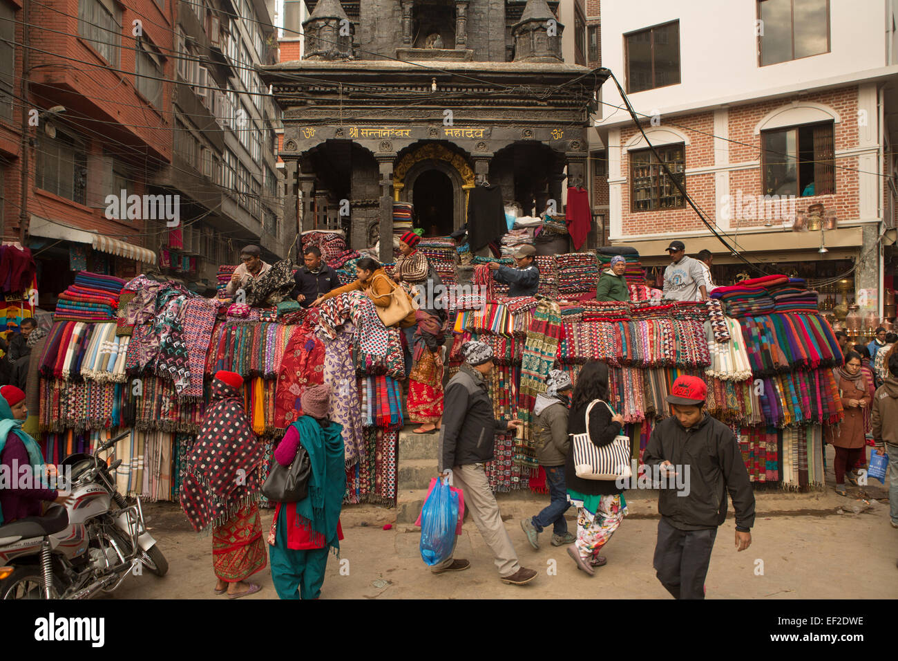 Carpet market beneath a temple amid the crowded streets of downtown Kathmandu, Nepal. Stock Photo