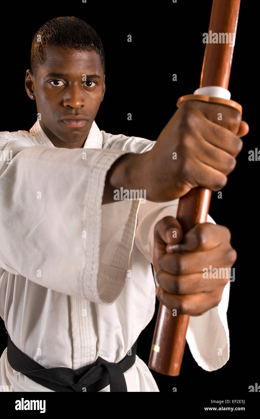 Young man practicing karate with a pole Stock Photo - Alamy