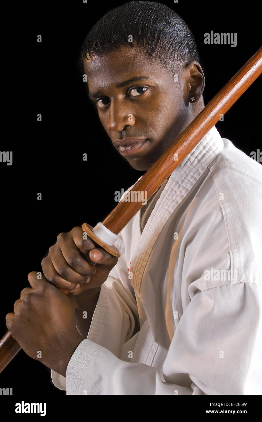 Young man practicing karate with a pole Stock Photo Alamy