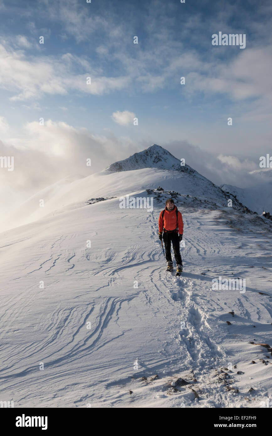 Walker on the snow covered ridge of Buachaille Etive Beag, Glencoe, Scottish Highlands, Scotland Stock Photo