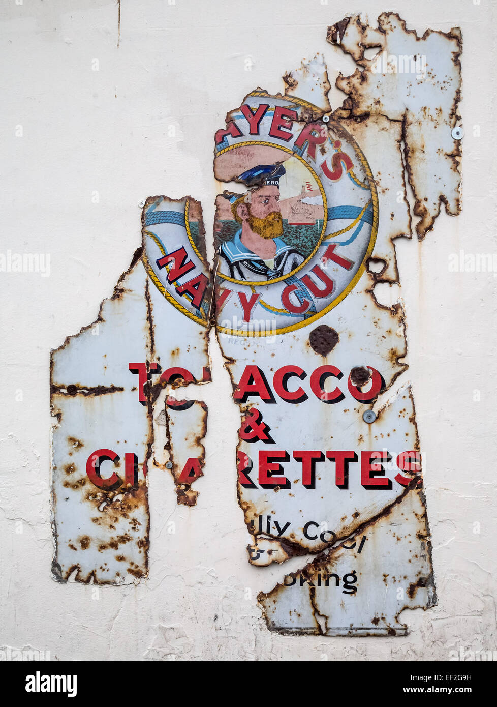 Player's Navy Cut Tobacco & Cigarettes original decaying metal sign Stock Photo