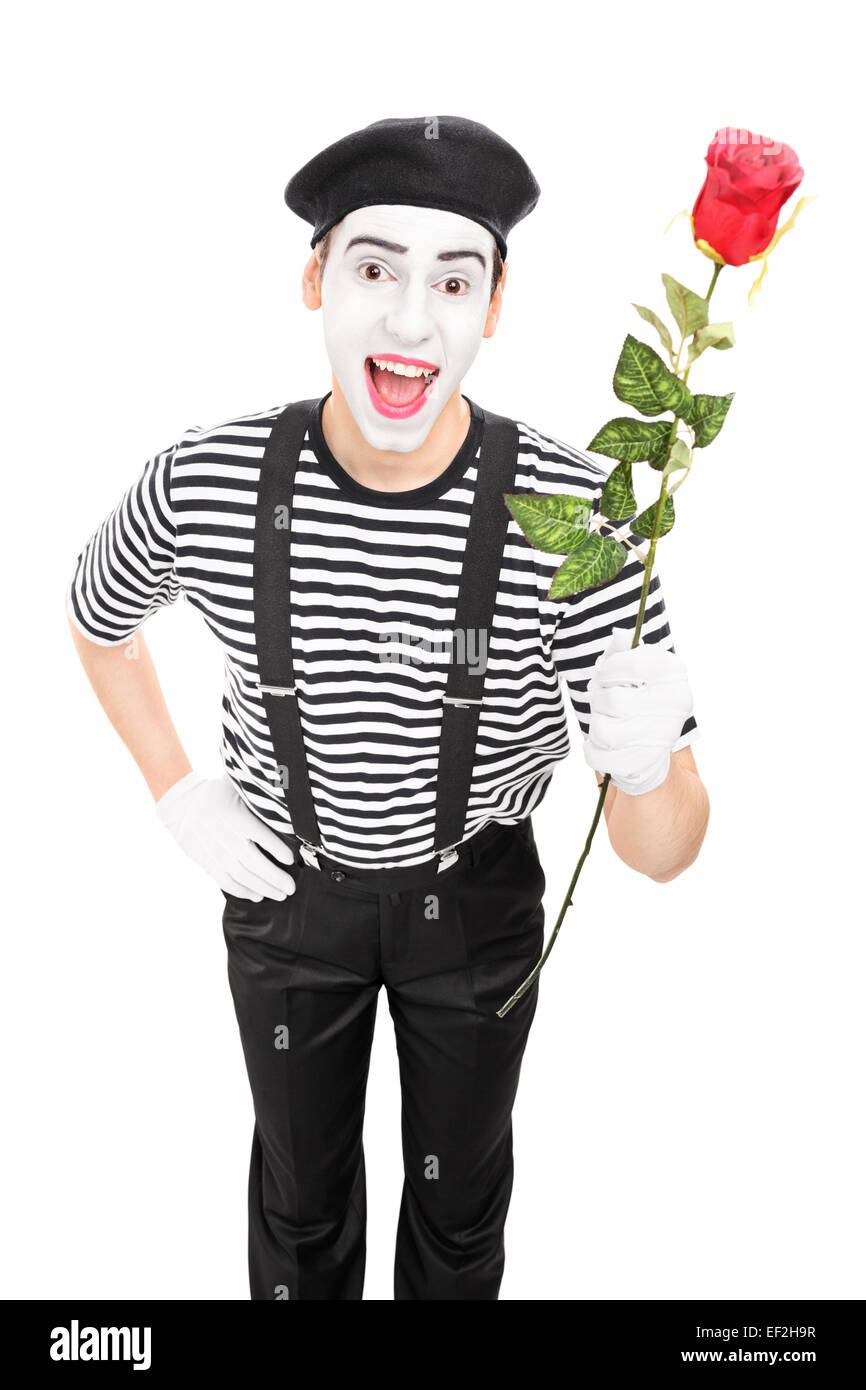 Vertical shot of a mime artist holding a red rose isolated on white background Stock Photo