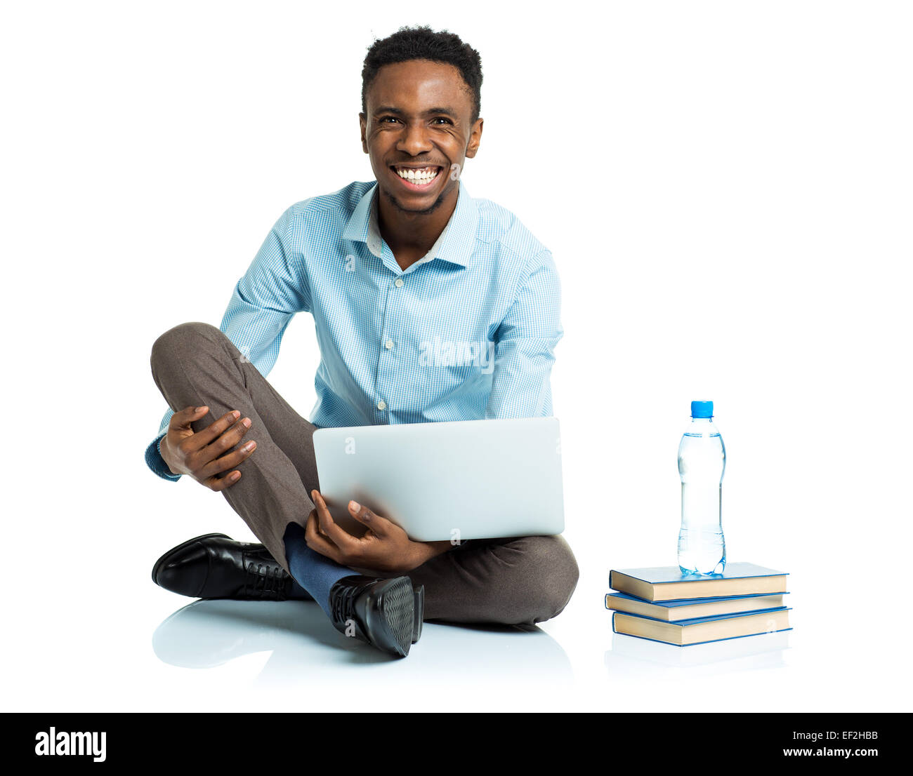 Happy african american college student sitting with laptop on white ...