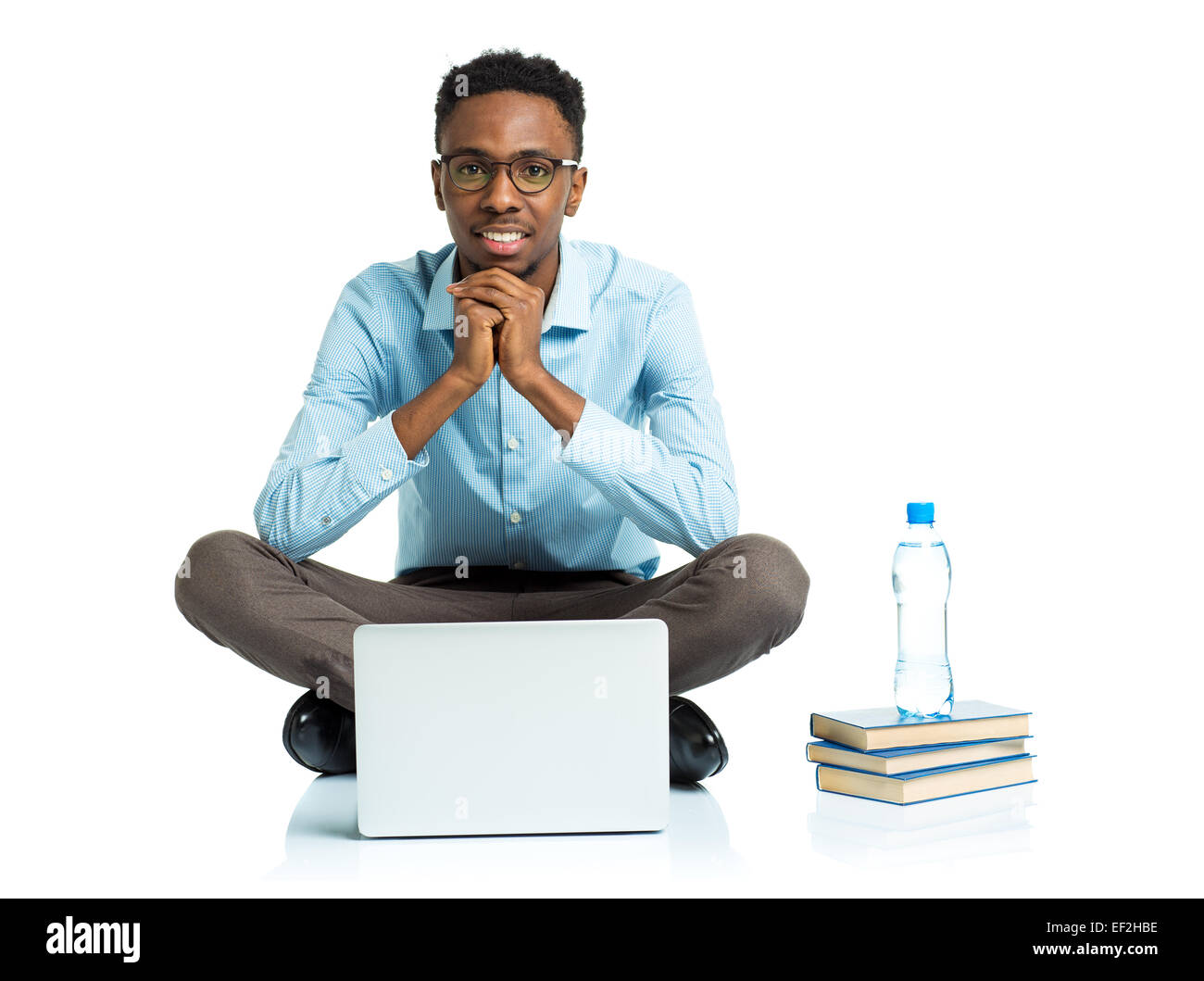 Happy african american college student sitting with laptop on white background Stock Photo