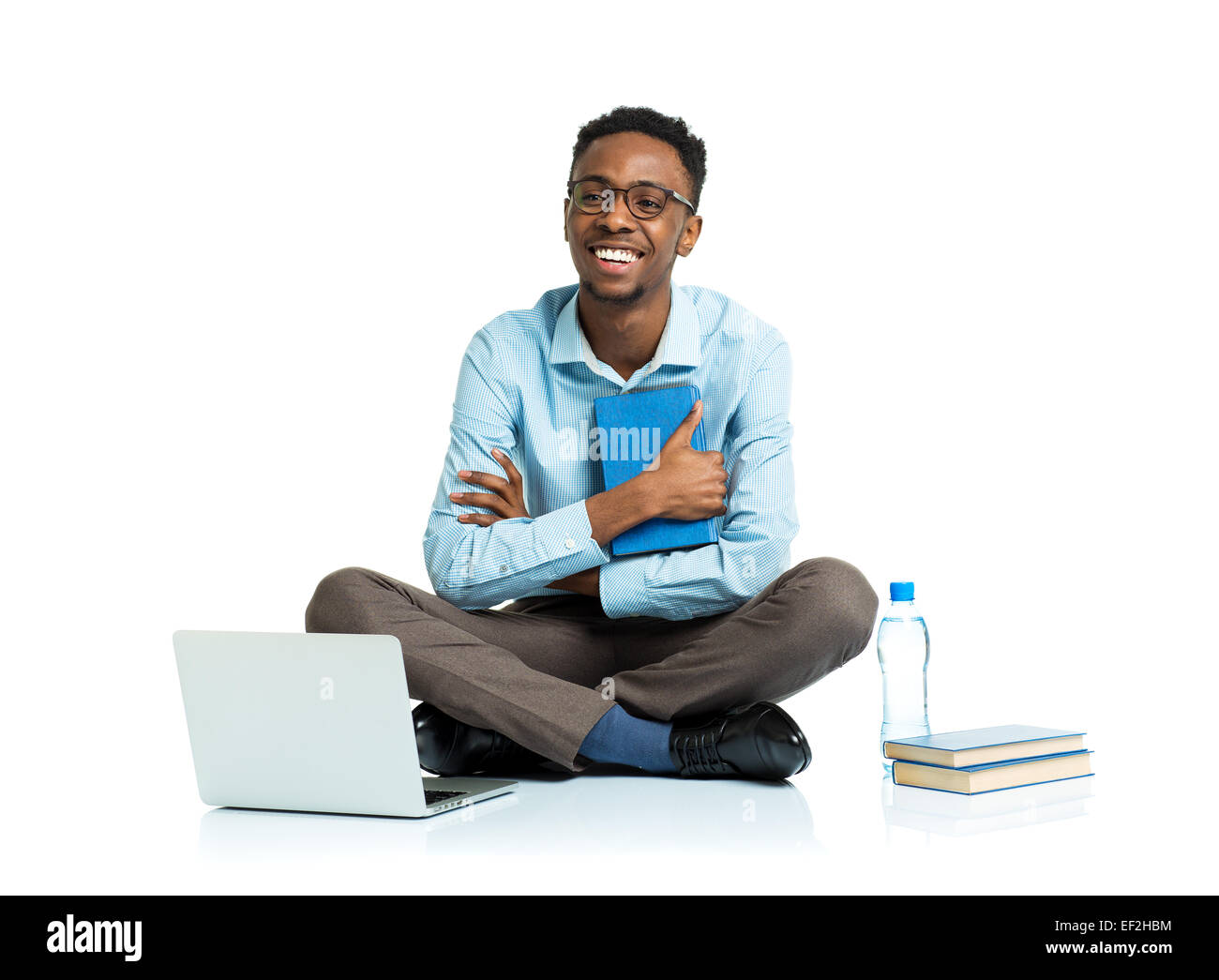 Happy african american college student sitting with laptop on white background Stock Photo