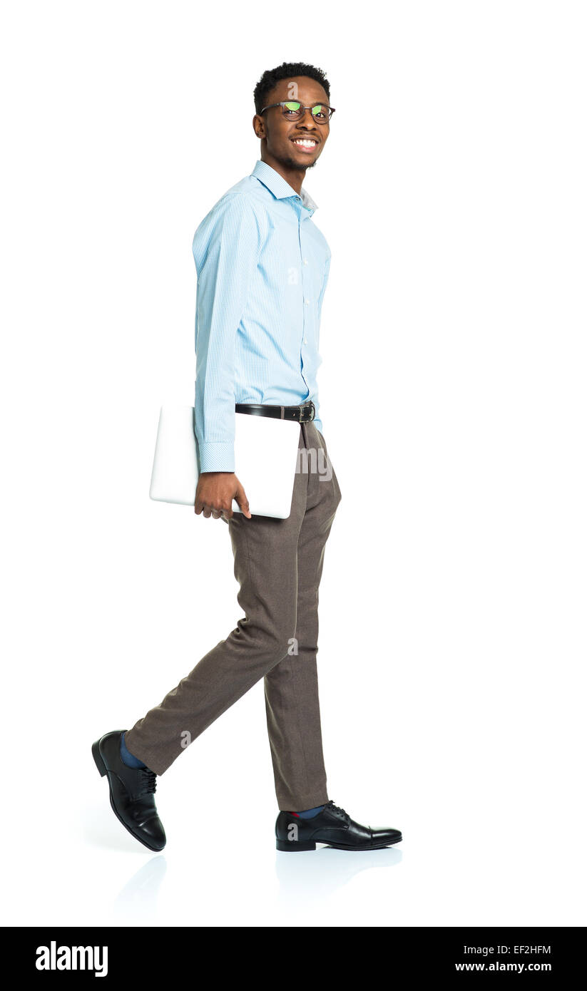 Happy african american college student standing with laptop on white background Stock Photo