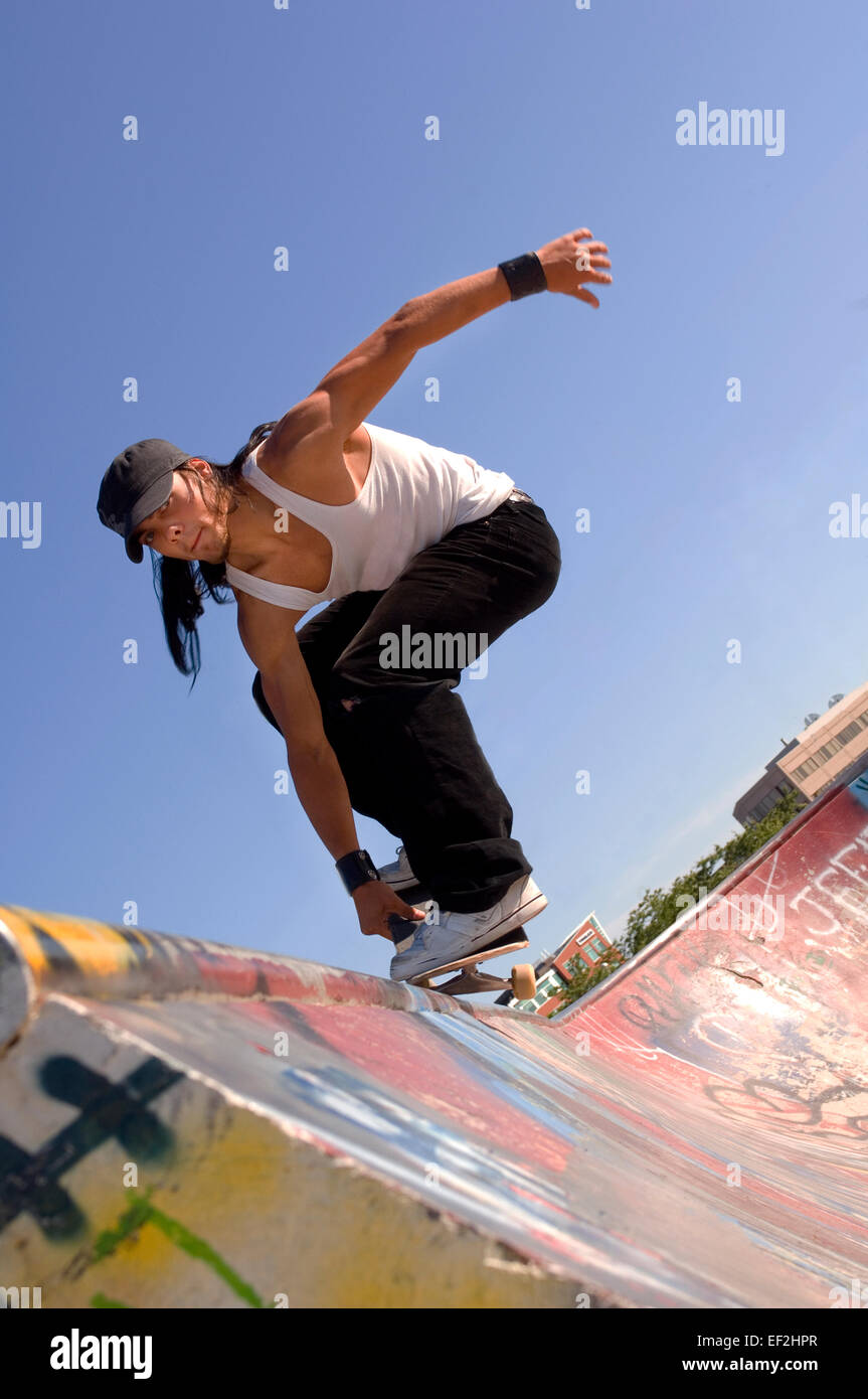 Skateboarder grinding a rail at a skate park Stock Photo - Alamy