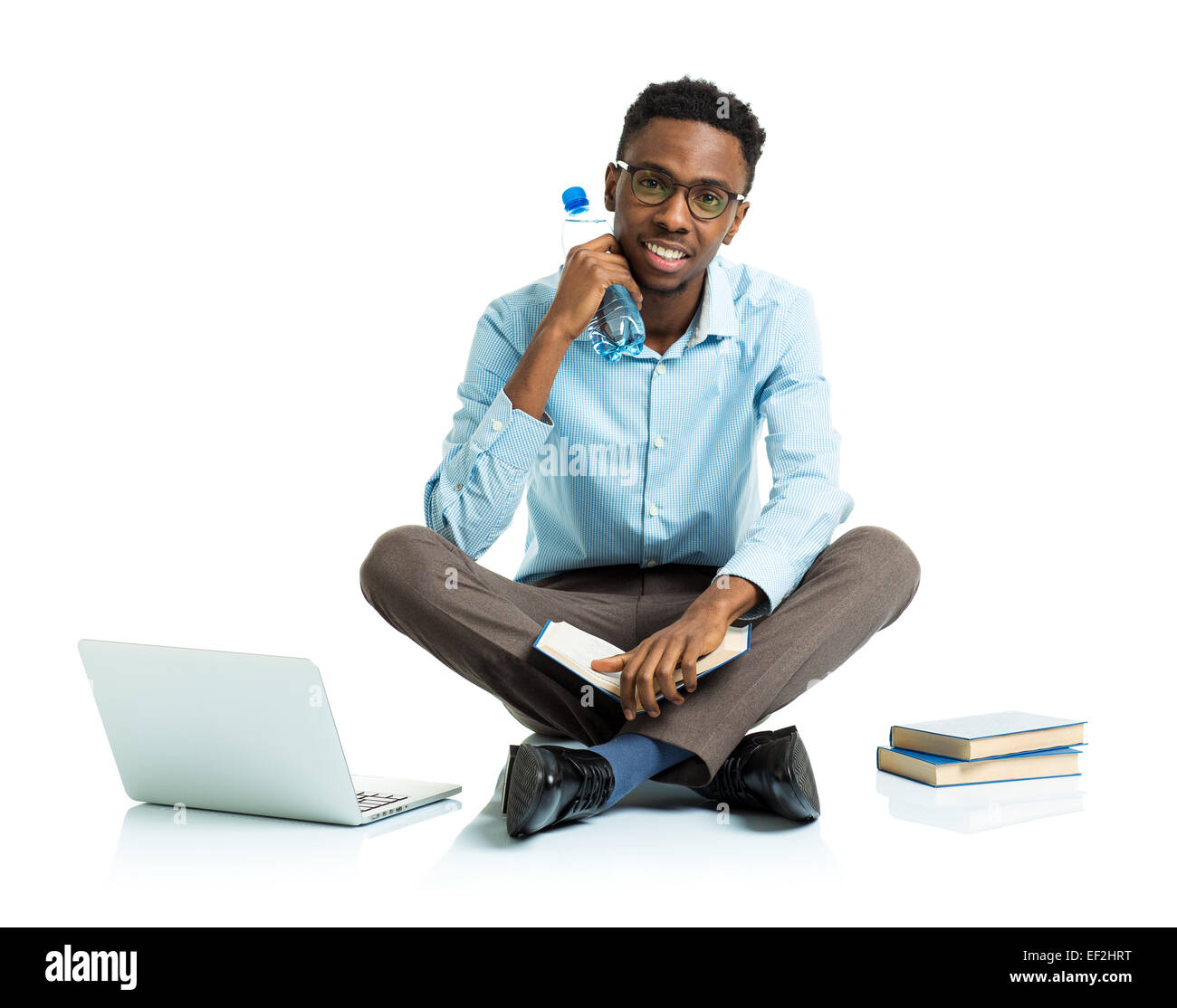 Happy african american college student sitting with laptop, books and bottle of water on white background Stock Photo