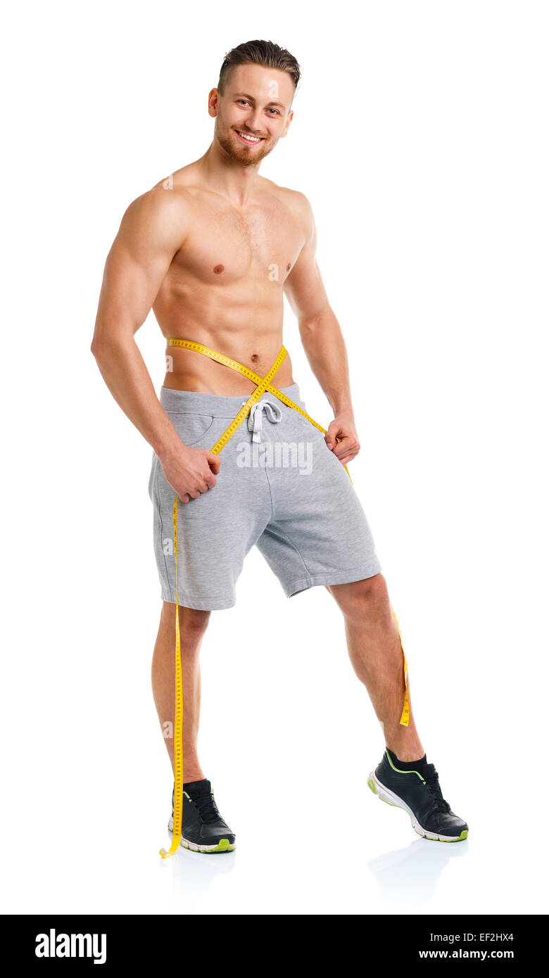 Athletic man with measuring tape on the white background Stock Photo