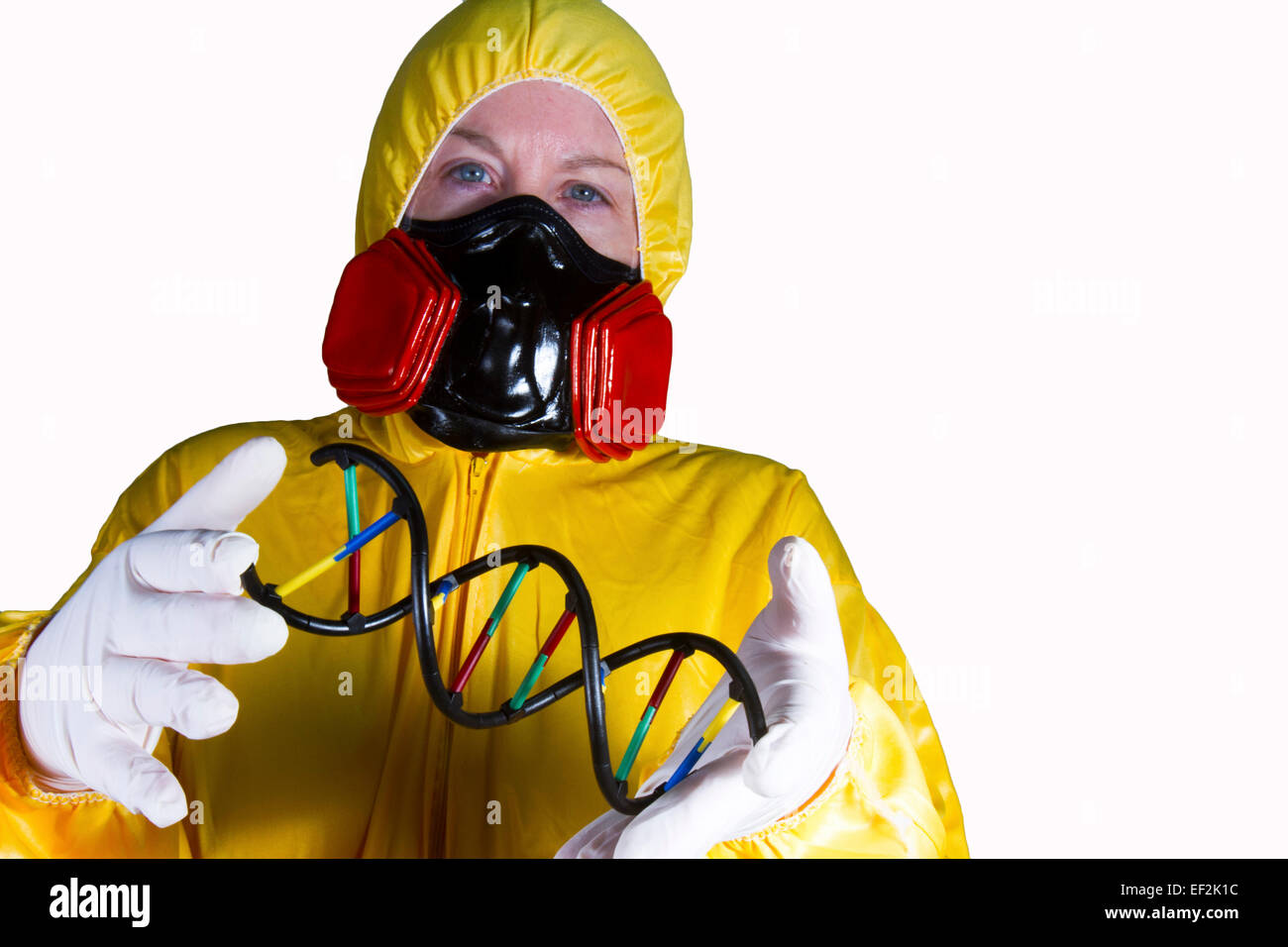 Woman dressed in HazMat suit with gas mask and shield with double helix Stock Photo