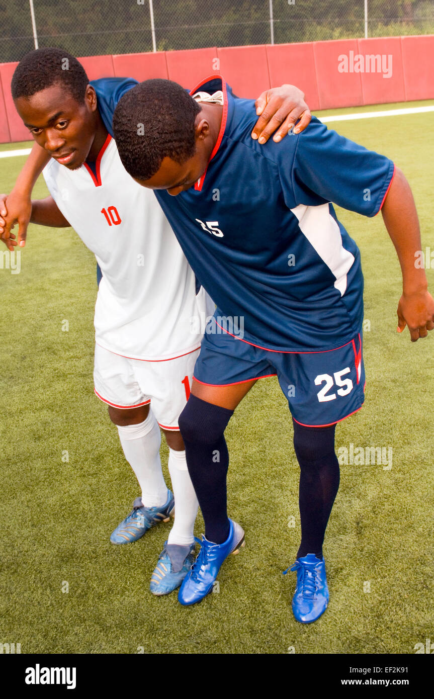 Soccer Player Helping Injured Opposition Player Stock Photo - Alamy