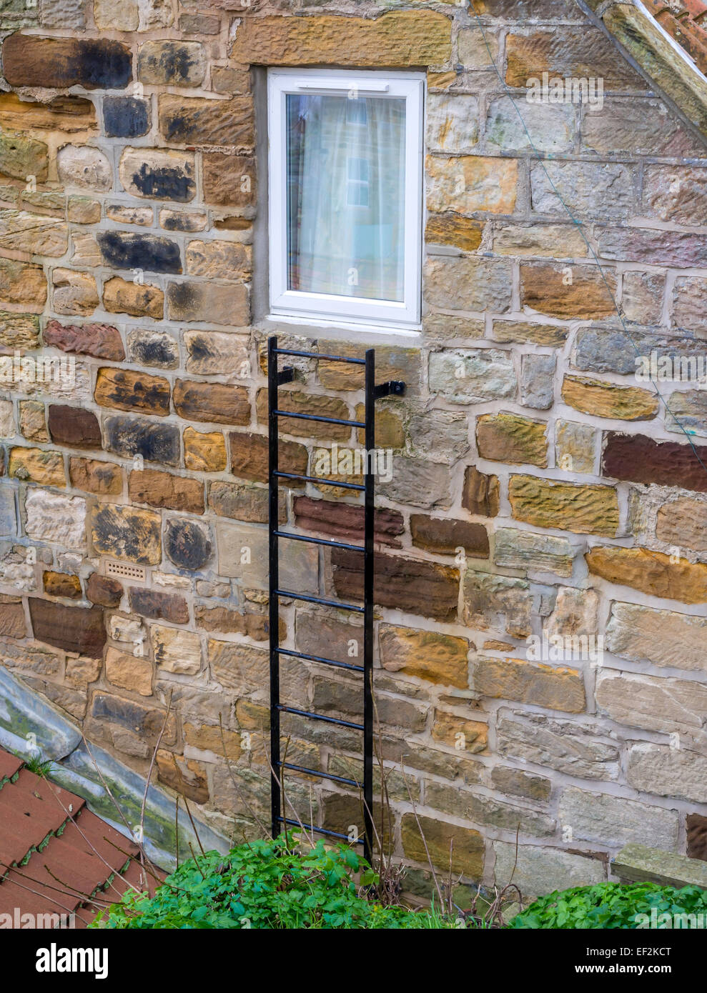 Simple steel ladder as an emergency escape route from upstairs room of a cottage in North Yorkshire Stock Photo