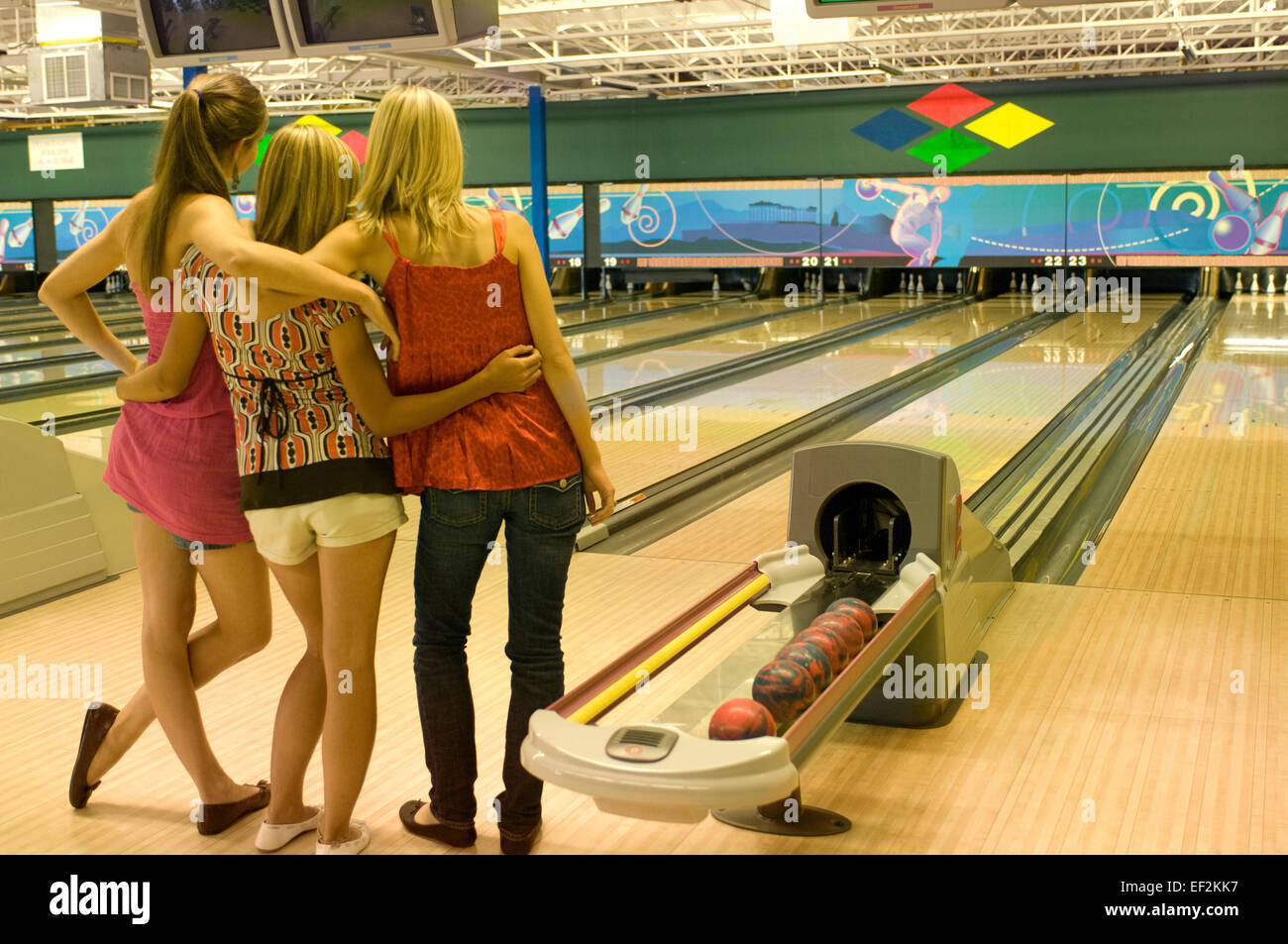 Group of girl friends bowling Stock Photo