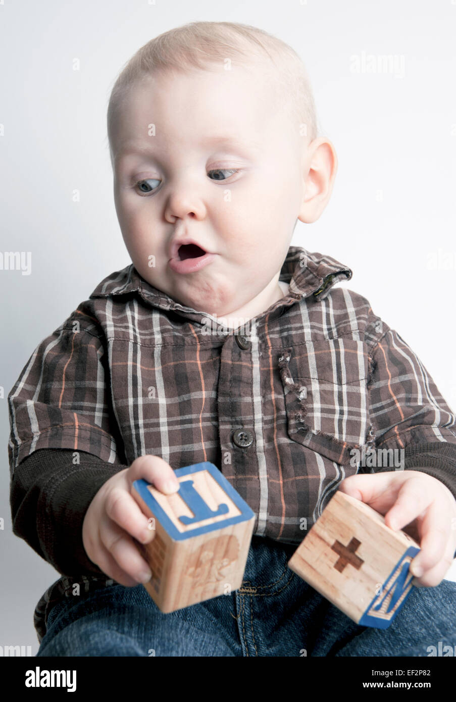 Nine month old baby boy smiling, laughing, playing with learning blocks Stock Photo Alamy